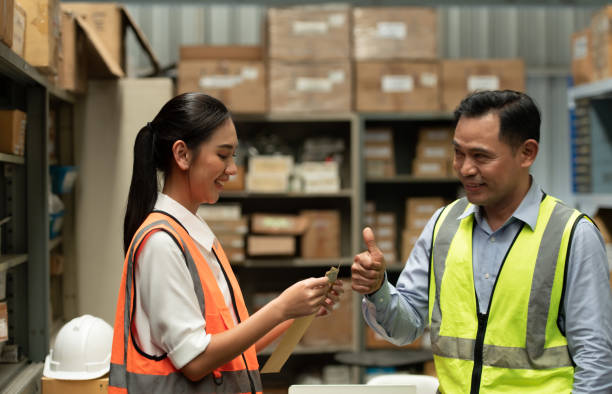 istock The warehouse manager gave the female assistant a premium. who assisted in the work and planning of the preparation of products to be sold to the retailers until it was very successful 1406830262