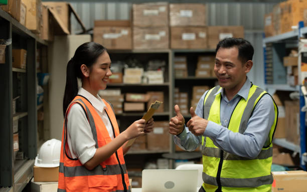 istock The warehouse manager gave the female assistant a premium. who assisted in the work and planning of the preparation of products to be sold to the retailers until it was very successful 1406830264