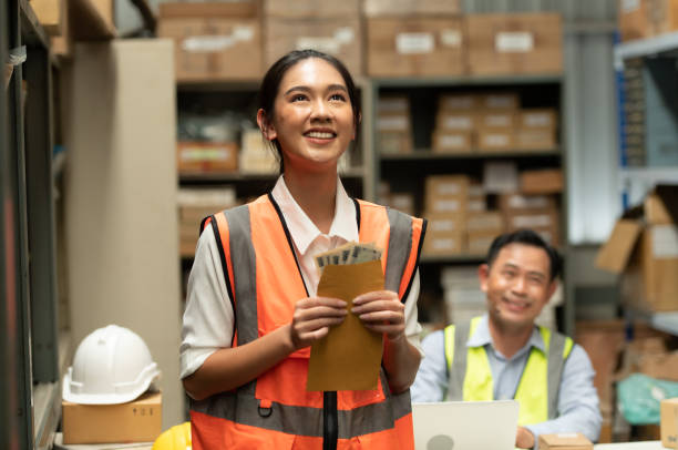 istock The warehouse manager gave the female assistant a premium. who assisted in the work and planning of the preparation of products to be sold to the retailers until it was very successful 1406830266