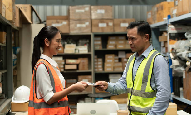 istock The warehouse manager gave the female assistant a premium. who assisted in the work and planning of the preparation of products to be sold to the retailers until it was very successful 1406830269