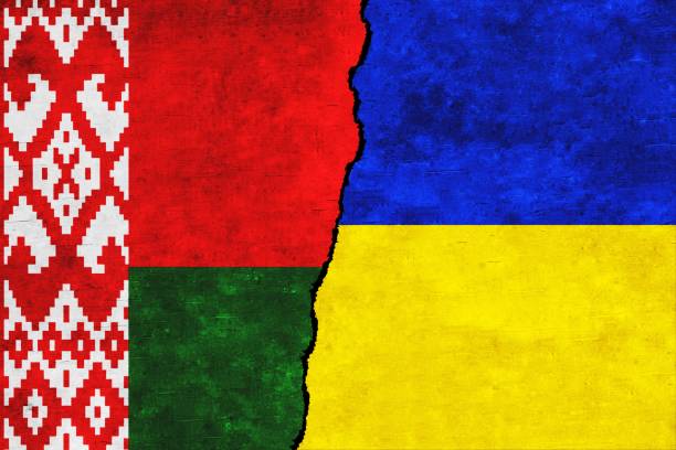 istock Ukraine and Belarus painted flags on a wall with a crack. Ukraine and Belarus relations. 1406831314