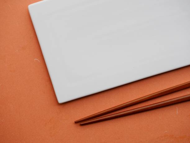istock White porcelain plate and wooden chopsticks 1406834404