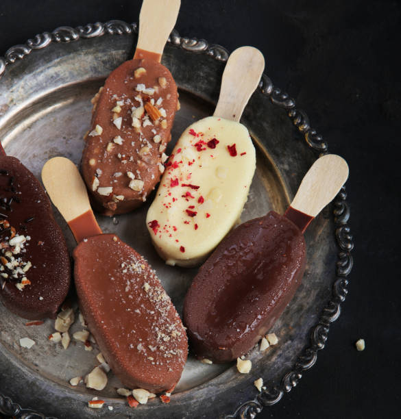 istock Popsicle ice-cream assortment on dark background. 1406837112