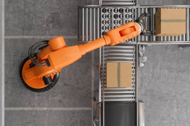 top view of robotic arm working on conveyor belt in smart warehouse - autonom teknik fotografier bildbanksfoton och bilder