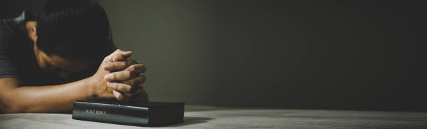 Banner image of Hands folded in prayer in church concept