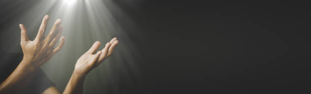 Banner image of Hands folded in prayer in church concept stock photo
