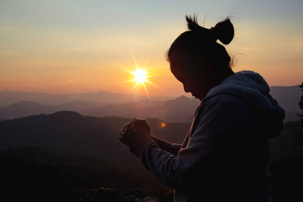 istock woman worship on sunset 1406839710