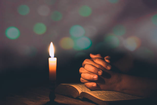 istock Woman hands praying on holy bible 1406839735