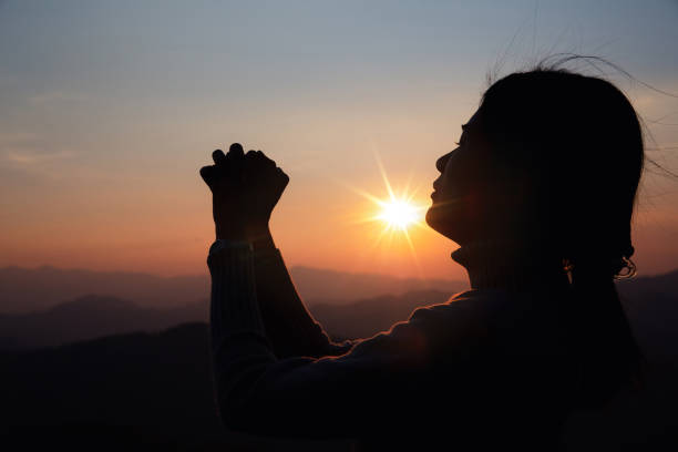 istock woman worship on sunset 1406839849