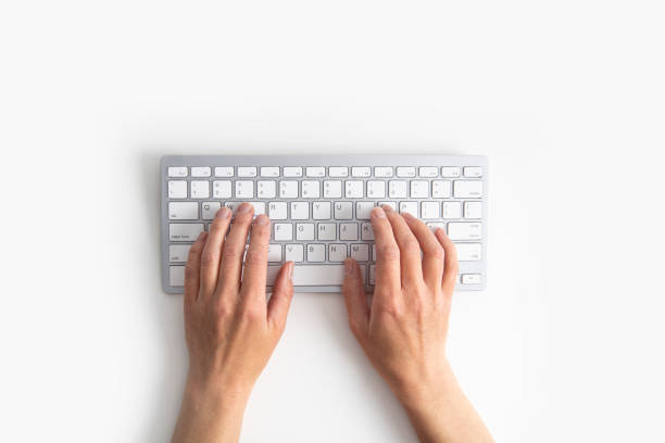 istock Female hands on the keyboard on a white background. Top view, flat lay 1406840397