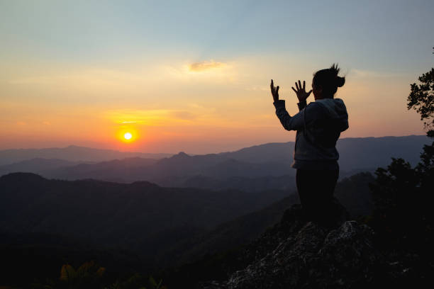 istock woman worship on sunset 1406840400