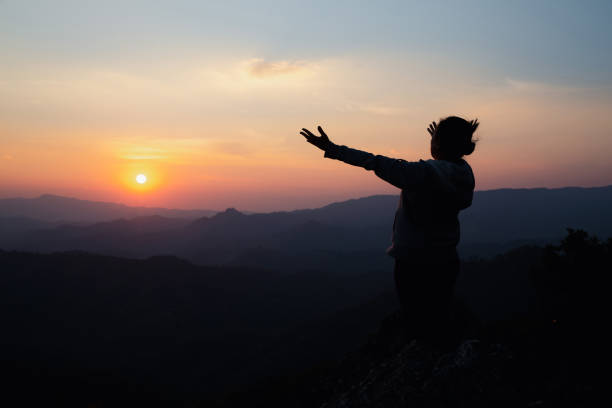 istock woman worship on sunset 1406840502