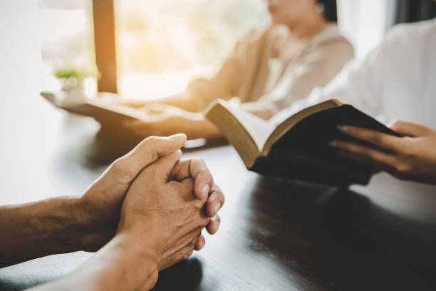 istock Group of people praying worship believe 1406840521