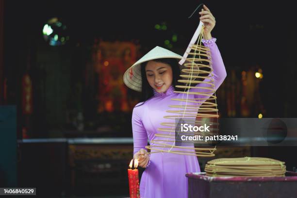 Vietnamese Woman In Traditional Dress Praying Stock Photo - Download Image Now - Vietnam, Fashion, Ao Dai