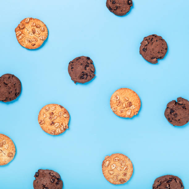 istock Chocolate cookies with chocolate, cookies with nuts on a blue background. Top view, flat lay. 1406840641