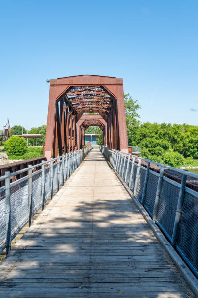 old rail bridge and dike trail on grand river, brantford, canada - ontario spring bicycle city life imagens e fotografias de stock