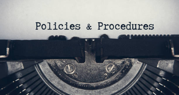 istock Policies and procedures text typed on an old vintage typewriter. Rules concept 1406844026
