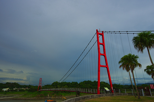 Red suspension bridge of Agongdian Reservoir. The first reservoir to be completed in Taiwan after World War II. Kaohsiung City, 2022