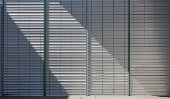 High resolution photograph of metal louvers of an office building.