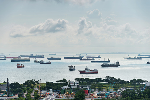 Container ships sailing in Singapore harbor.