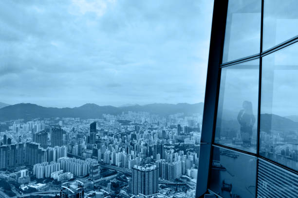 Business woman looking through the window.