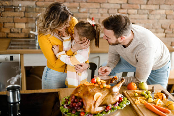 istock Happy family talking during Thanksgiving day in the kitchen. 1406852244