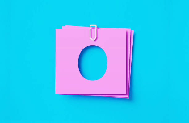 istock Number 0 Written Cut Out Pink Adhesive Notes Sitting Over Blue Background 1406854779