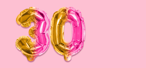istock Rainbow foil balloon number, digit thirty on a pink background. Birthday greeting card with inscription 30. 1406856449