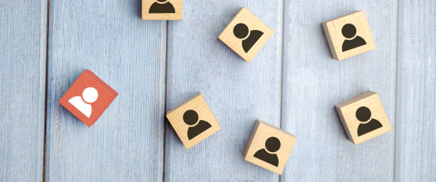 istock wooden cube blocks with printed blue human symbol. Leadership and team building concept 1406857959