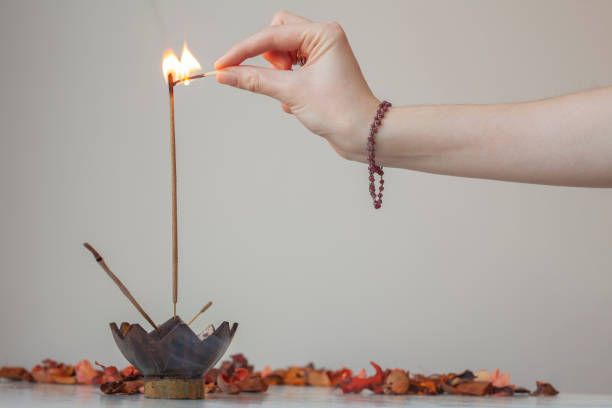 istock Person lighting an Indian incense stick with match. 1406858007