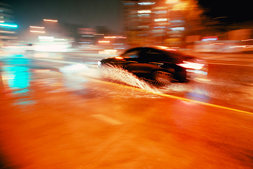 Blurred car  in wet weather with water..  Abstract.