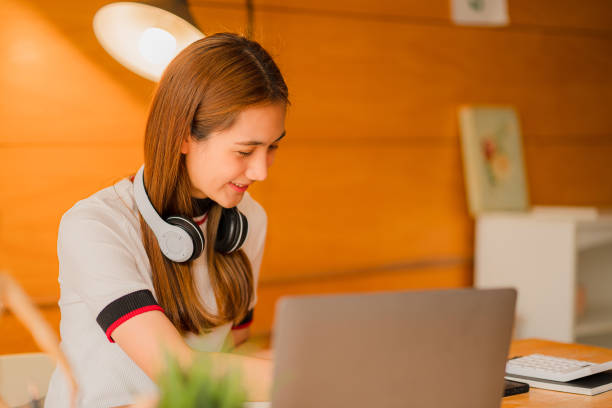 istock Asian young woman working with laptop computer and financial documents at home online study and work concept 1406859046