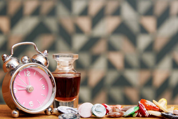 istock Small fancy alarm clock, perfume bottle, buttons on the bed table 1406860731