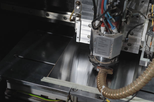 istock Manufacture of electronic chips. High-tech, close-up. Process of creating a printed circuit board. Machine for production of PCB. Manufacturing of printed circuit boards. 1406861934