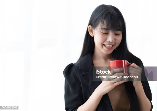 Portrait Of Young Successful Businesslady On A Coffee Break She Is Resting And Enjoying The Drink Woman Is On A White Background Stock Photo - Download Image Now