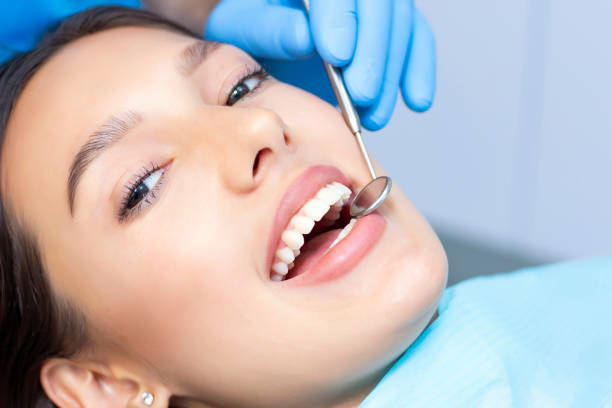 istock dentist examines the patients teeth at the dentist. 1406863148