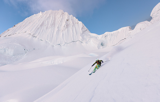 Active lifestyle, Vital senior men snow skier skiing, enjoying on sunny ski resorts. Skiing carving at high speed.  Alps  ski area. Ski resort Livigno. italy, Europe.