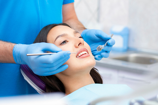 dentist examines the patients teeth at the dentist.