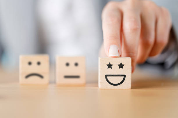 istock Customer hand choose smiley face on wood cube, Service rating, satisfaction concept 1406863797