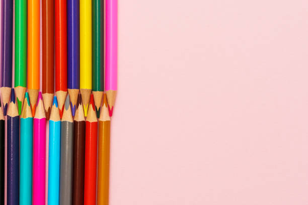 istock Colored wooden pencils on pink background, education concept. 1406864457