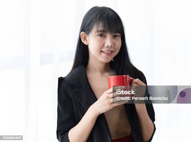 Portrait Of Young Successful Businesslady On A Coffee Break She Is Resting And Enjoying The Drink Woman Is On A White Background Stock Photo - Download Image Now
