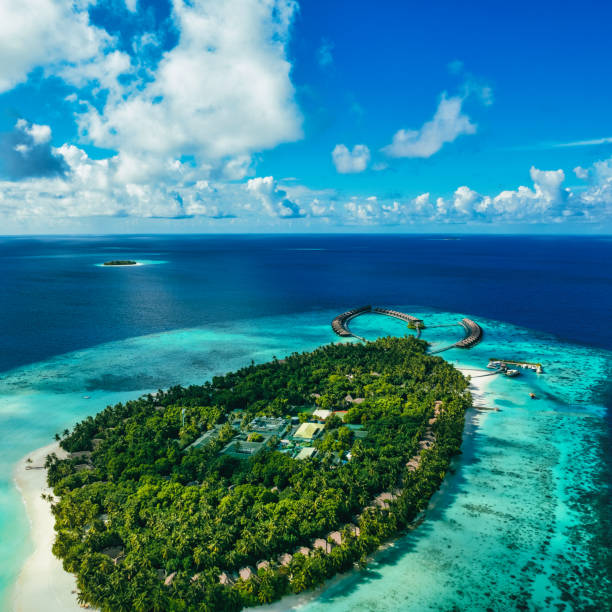 Aerial view of tropical island and shallow reef lagoon stock photo