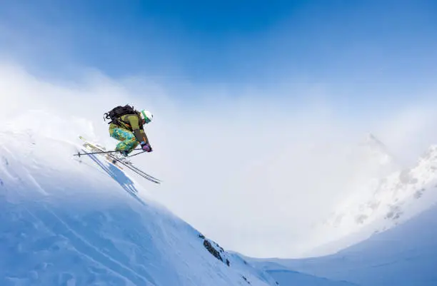 Freeride skier skiing a steep snow slope