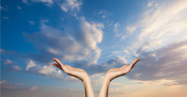 istock Hands on blue sky clouds background. Power of hope or love and devotion 1406866612