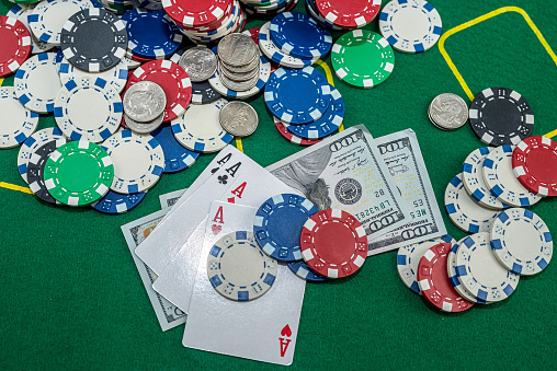 many colored chips of cards and dollars are scattered for poker. Love to play poker