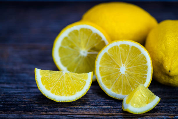 istock Group of fresh yellow lemon fruit on wood background 1406868719