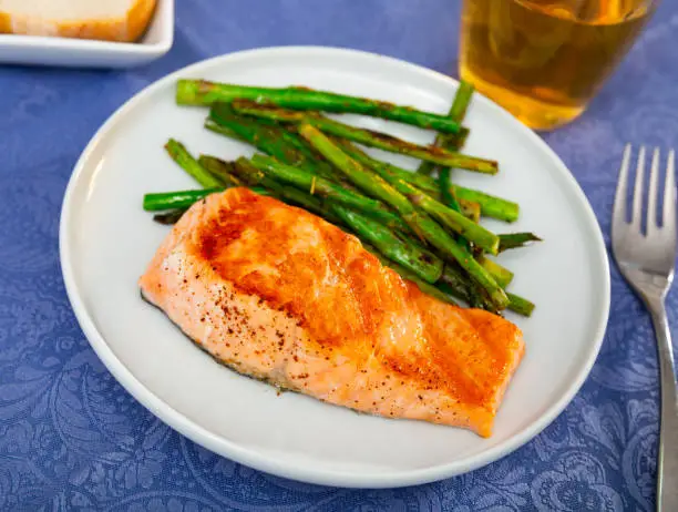 Photo of Grilled salmon filet with asparagus on plate