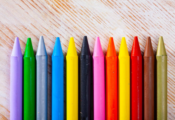 istock Colorful crayons on wooden surface 1406869040