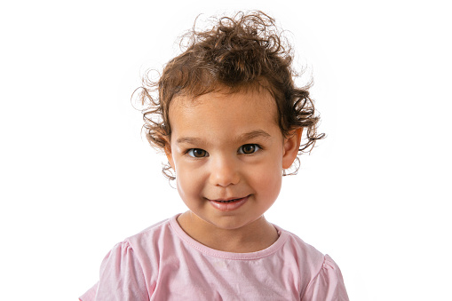 Mixed race Smiling little girl looking at the camera from behind