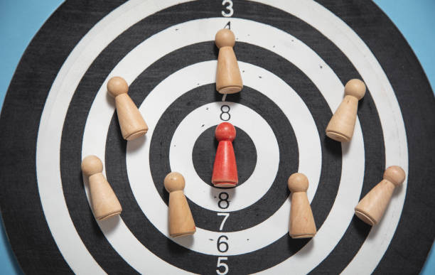 istock Wooden human figures on target dartboard. Target. Success. Business 1406870810